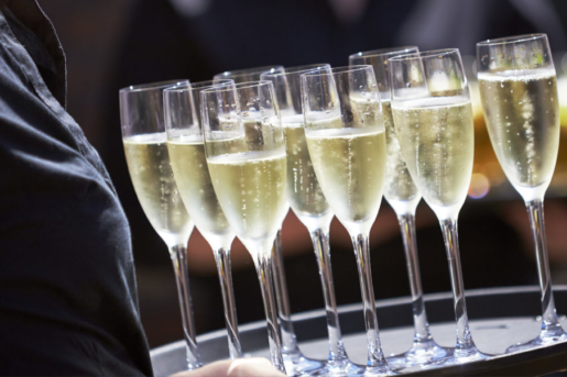 Tray of Champagne drinks being served on a sunny day outdoors