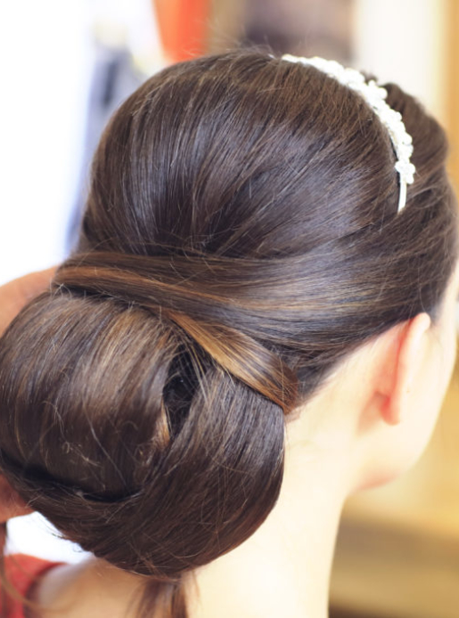 Brunette bride having her hair done for her wedding at Mercure Hotels