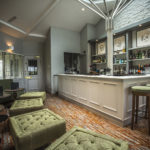 the bar at Mercure Bristol North The Grange Hotel with stools and tables