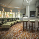 the bar at Mercure Bristol North The Grange Hotel with stools and tables