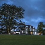 Image of the exterior and grounds at night time at Mercure Bristol North The Grange Hotel