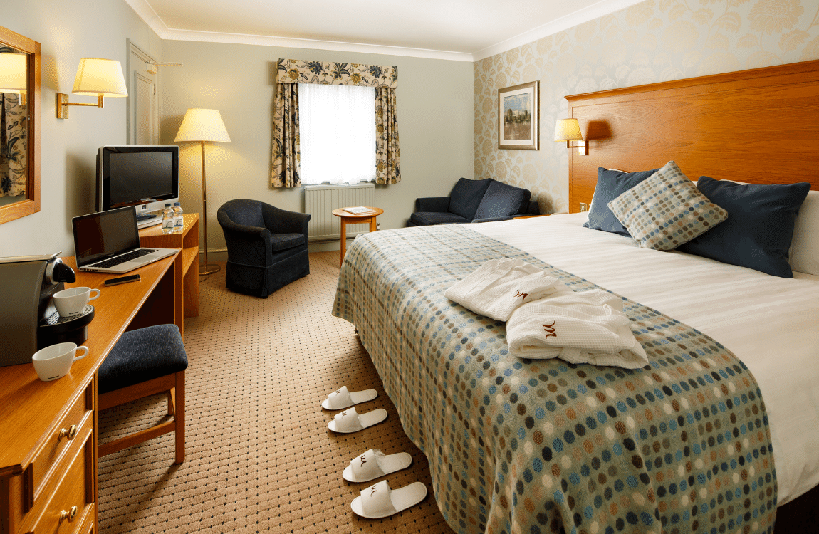 Double bed and headboard in a Privilege Room at Mercure Hotels